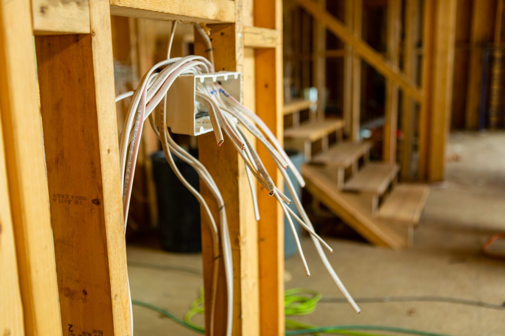 A bunch of wires hanging from the side of a wall.